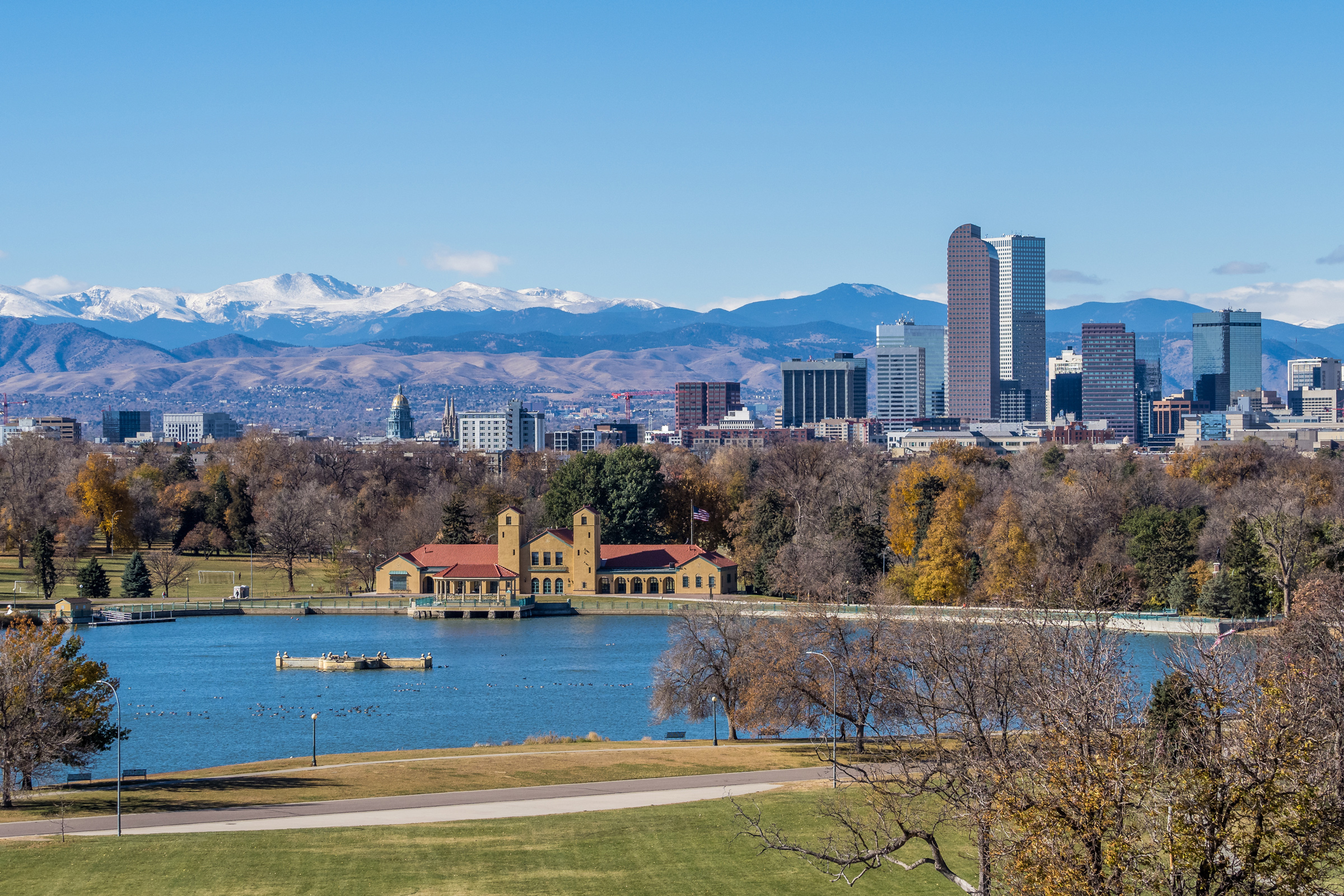 Denver skyline with mountains and city park lake