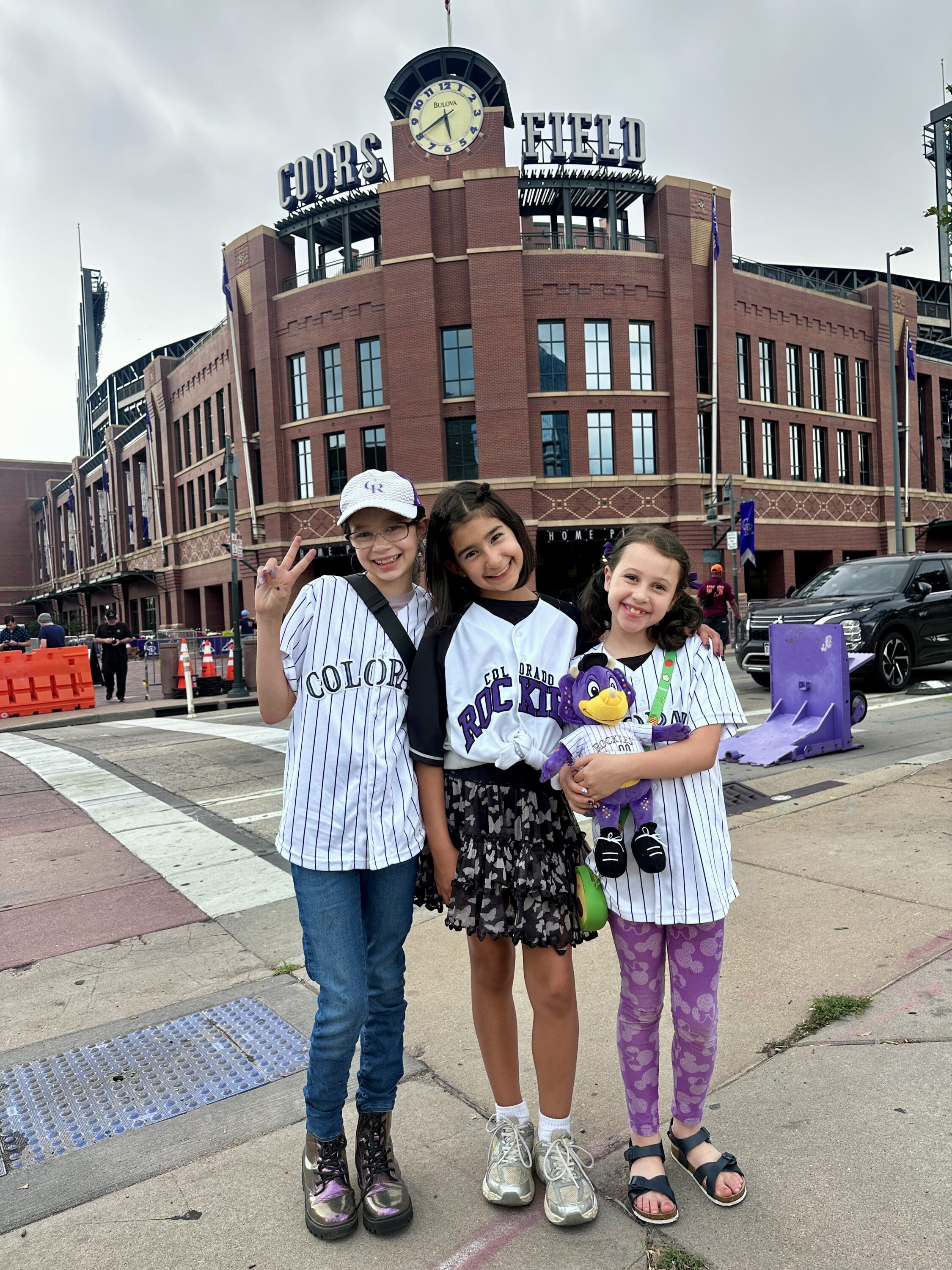 Kids in Rockies jerseys outside Coors Field stadium