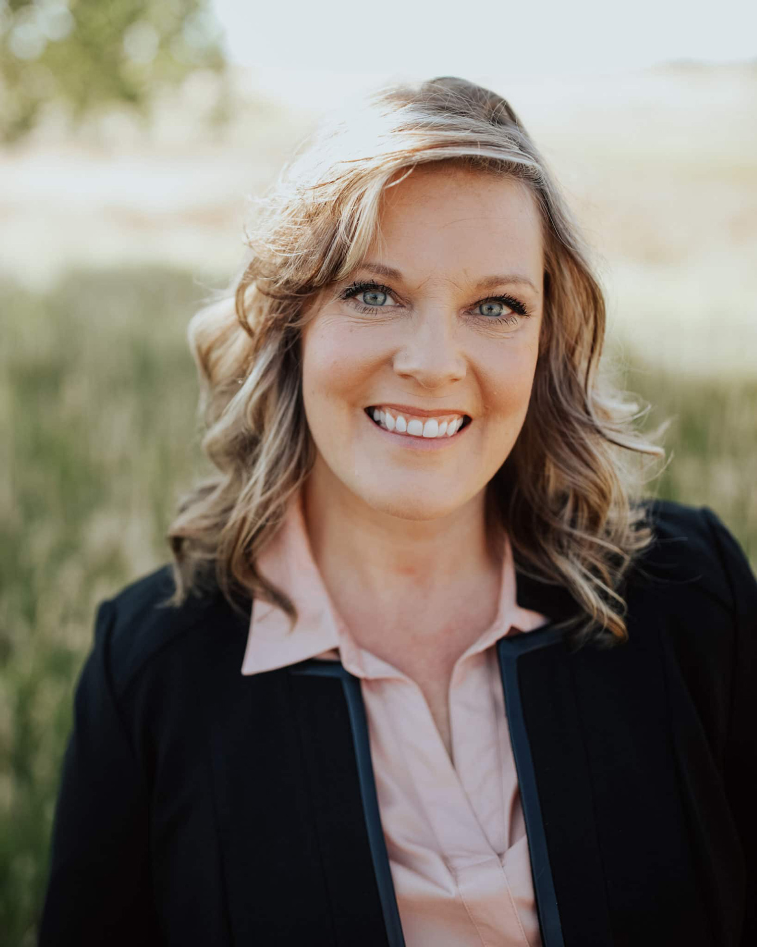 Smiling woman in outdoor field portrait