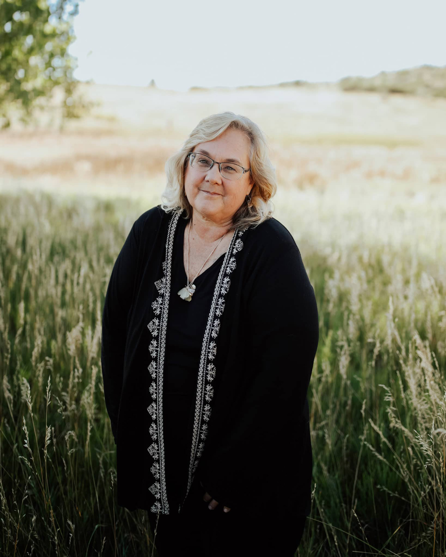 Woman standing in grassy field outdoors