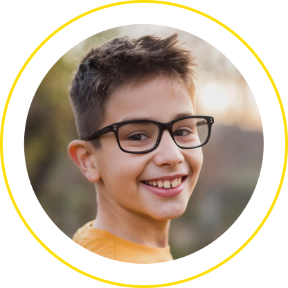 Smiling child wearing glasses outdoors