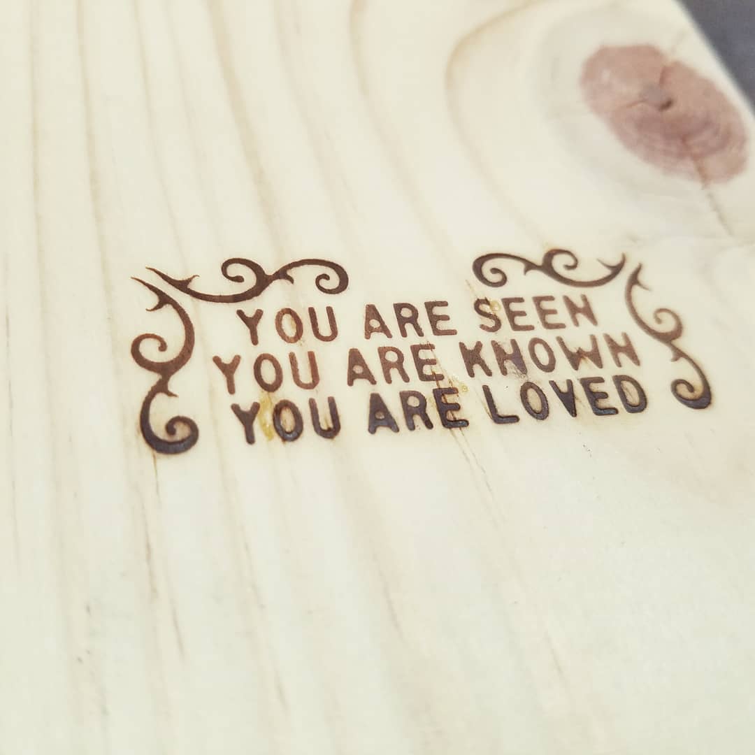 Inspirational quote engraved on wooden surface
